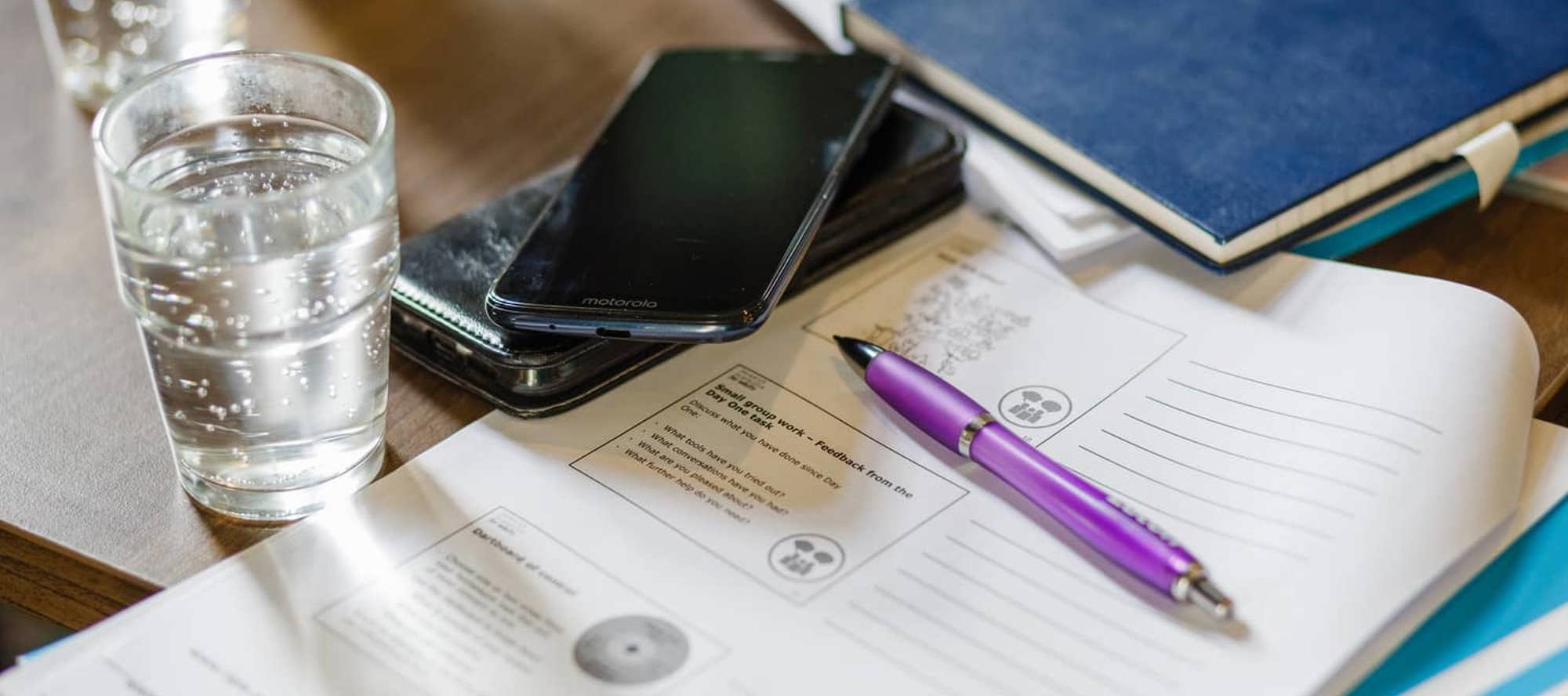 mobile phone and papers on a table